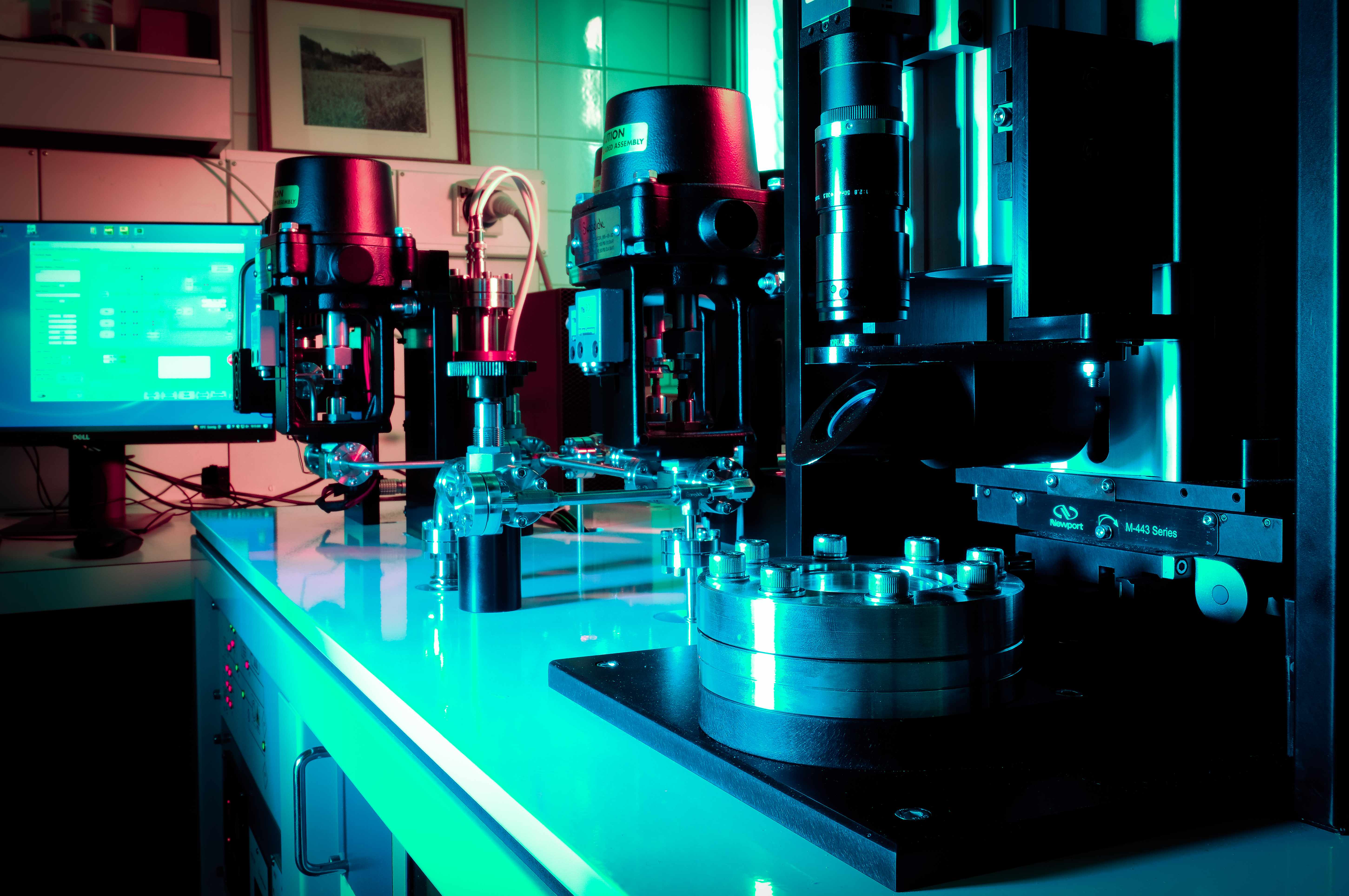 Alphachron precision equipment and optical assemblies under teal lighting